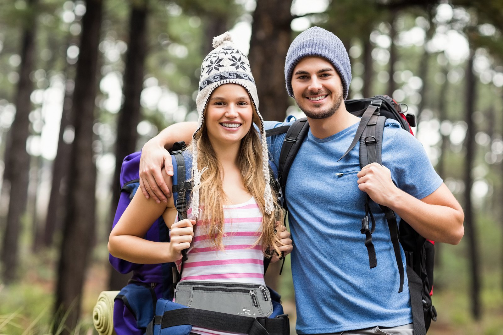 Two hikers on a forest trail wearing the Alpine Rivers money belt under their clothing.