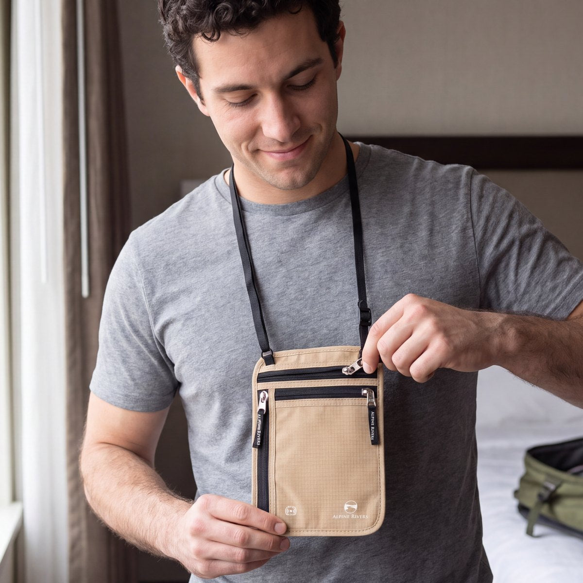Man in a hotel room opening the zip of a Sahara Sand Alpine Rivers RFID neck wallet worn around his neck (AI-generated image)