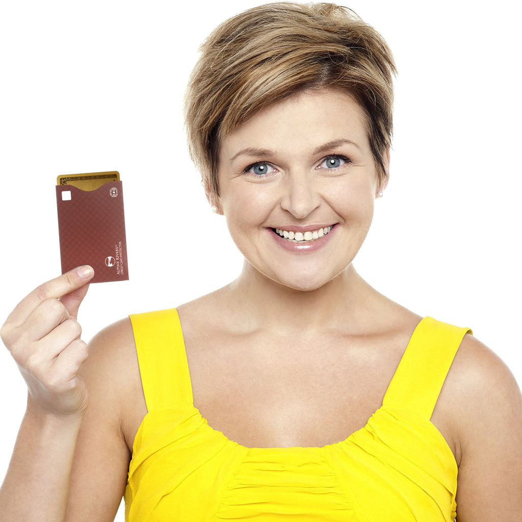 Brown Alpine Rivers RFID blocking card sleeve, top-load, held by a traveler